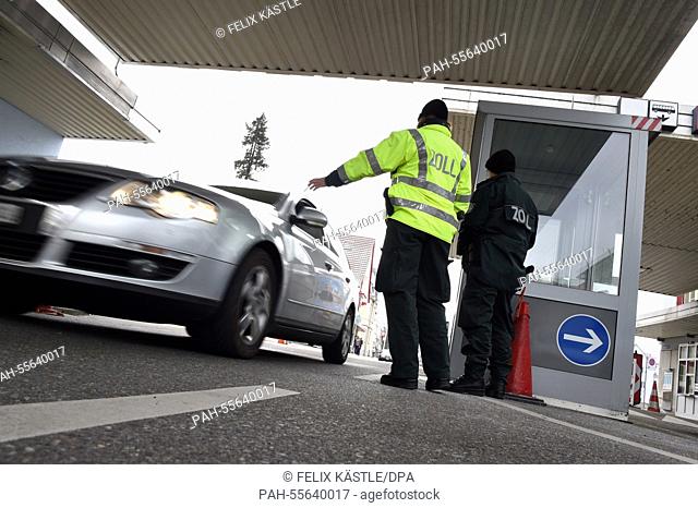 A customs officer stops the car of a Swiss citizen passing the border to Germany at Konstanz, Germany, 6 February 2015. PHOTO: FELIX KAESTLE/dpa | usage...