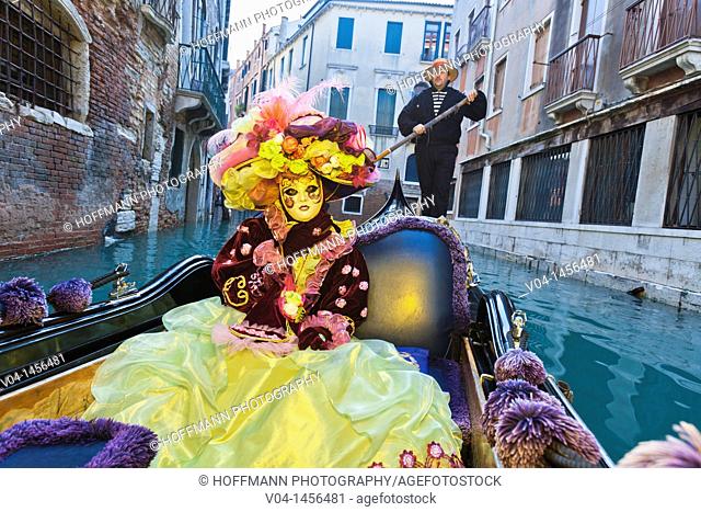 A masked woman in a gondola at the carnival in Venice, Italy, Europe