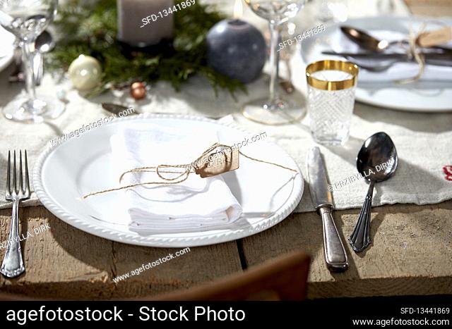 Place setting with a white napkin on Christmas table