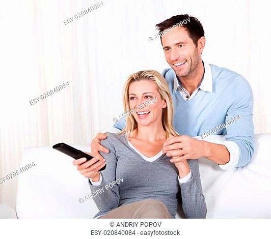 Cheerful couple watching TV