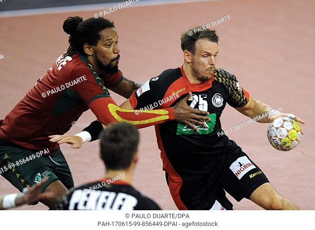 GermanyÂ·s Kai Hafner, right, is challenged by PortugalÂ·s Gilberto Duarte during the Euro 2018 Qualification Group 5 handball match between Portugal and...