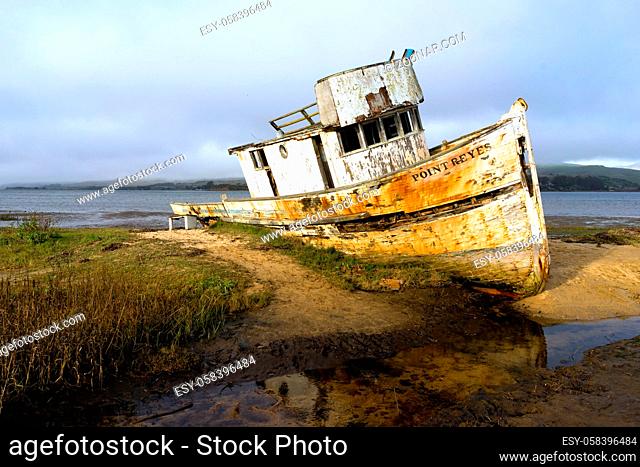 An old beached boat lay rotting away forgotten at Point Reyes in California