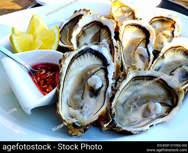 Oysters on a plate with shallot vinegar and lemon