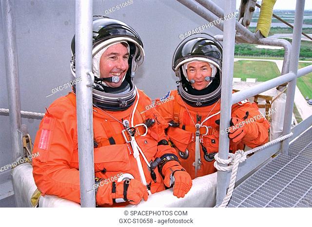 07/23/1997 -- STS-85 Mission Specialist Stephen K. Robinson left and Payload Specialist Bjarni V. Tryggvason check out an emergency egress slidewire basket at...