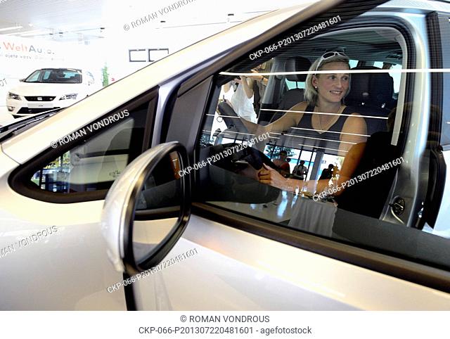 Czech athlete Barbora Spotakova poses in the car which she received on July 22, 2013 in Prague, Czech Republic. (CTK Photo/Roman Vondrous)