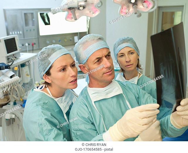 Surgeons preparing for surgery in operating room