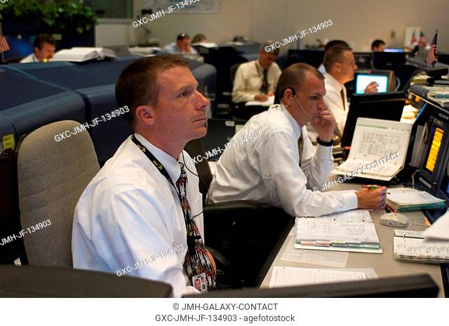 Astronauts Terry W. Virts Jr. (foreground) and Dominic A. (Tony) Antonelli, spacecraft communicators (CAPCOM), monitor data at their consoles in the space...