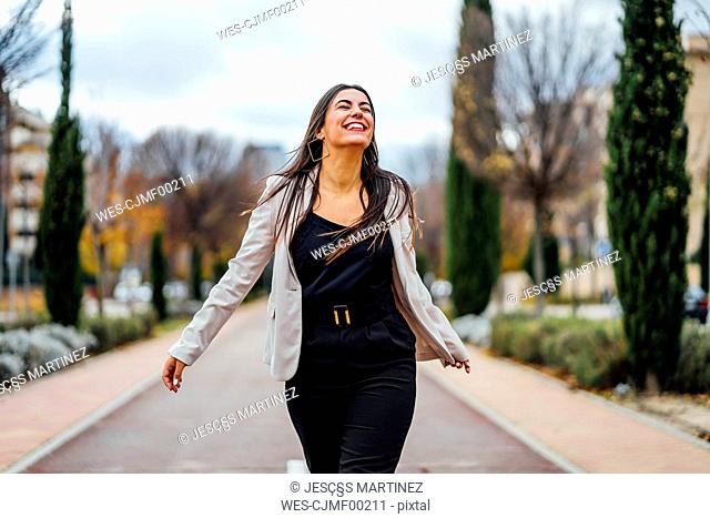 Smiling businesswoman walking and laughing