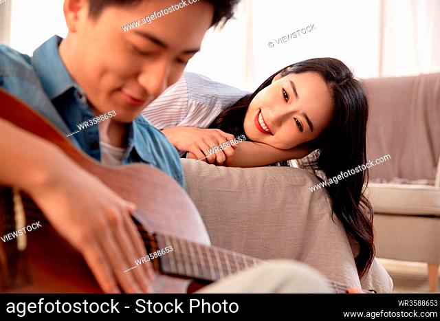 Young man singing to his girlfriend