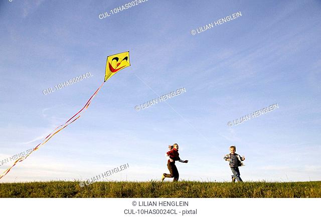 Girl and Boy fly a Kite