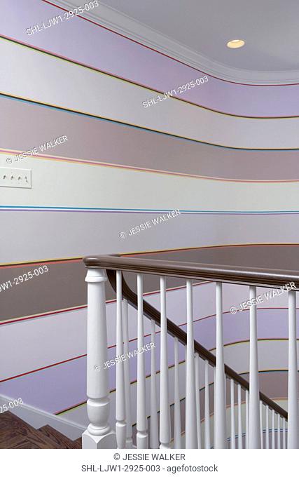Staircase: View from landing towards left wall, stairwell has decorative paint job, horizontal bands of color in lavenders to taupe