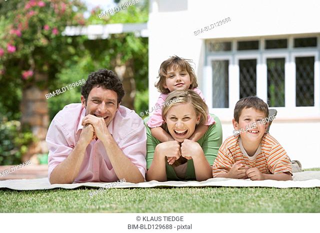 Caucasian family relaxing in backyard