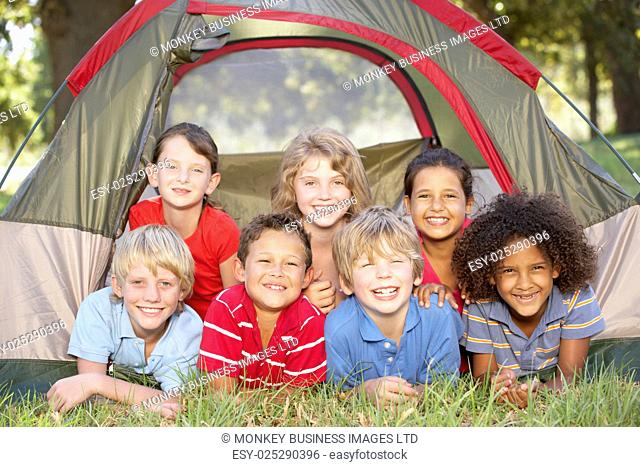 Group Of Children Having Fun In Tent In Countryside