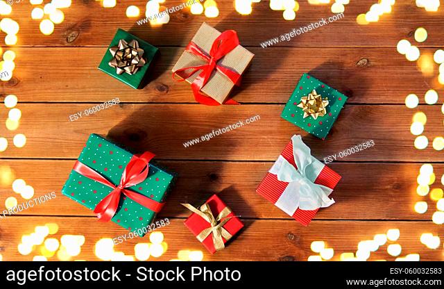 christmas gifts on wooden boards over lights
