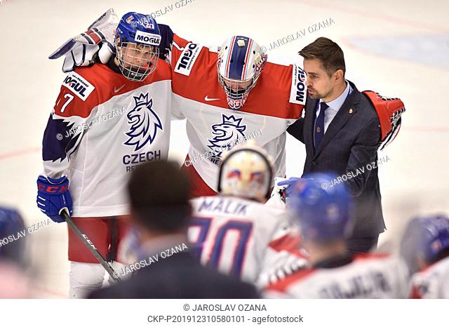 Injured Czech goalkeeper Lukas Parik, center, leaves ice during the 2020 IIHF World Junior Ice Hockey Championships Group B match between Canada and Czech...