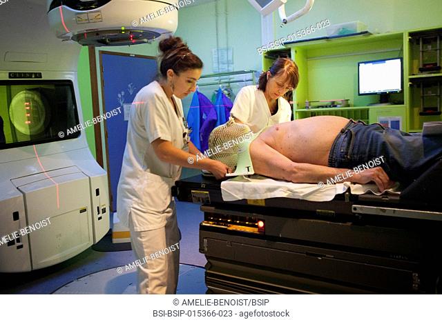 Reportage in the radiotherapy unit of a hospital in Savoie, France. Two technicians set up a patient for a radiotherapy session to treat cervical and dorsal...