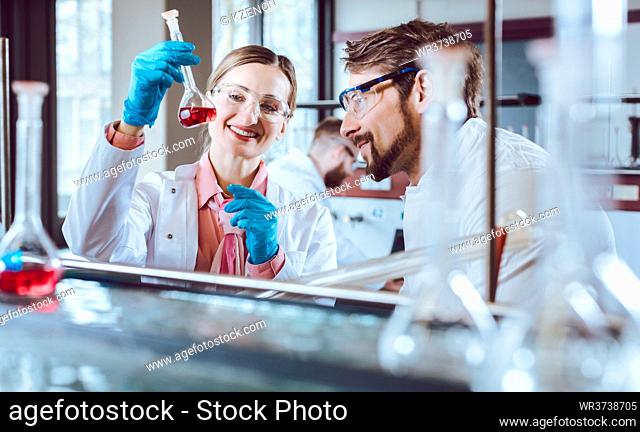 Analytical Chemists working in the lab looking at test result