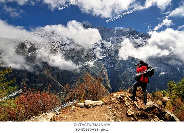 Photographer in the Himalayas on way from Namche Bazaar to Tengboche, Nepal