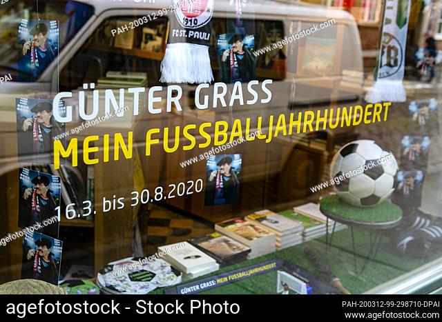 12 March 2020, Schleswig-Holstein, Lübeck: An event announcement is fixed on a window pane. The exhibition ""Günther Grass: My Football Century"" will be opened...