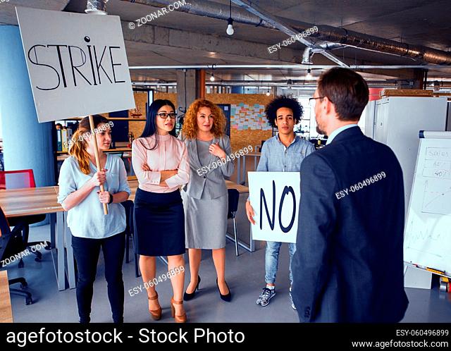 Loft style modern office, employees striking. Director negotiating with striking business team. Toned concept