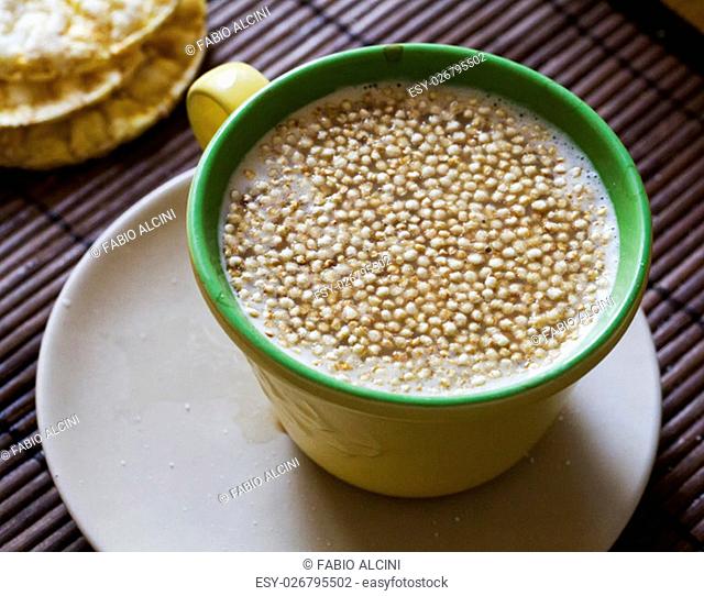 Quinoa flakes in milk cup, horizontal image