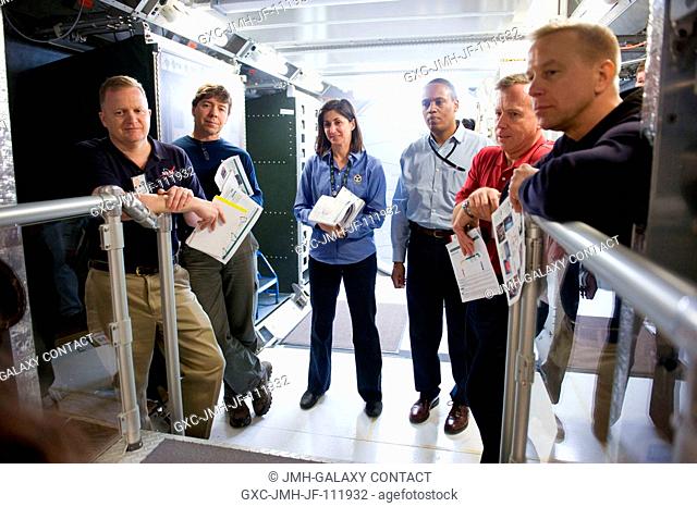 STS-133 crew members participate in a training session in an International Space Station mock-uptrainer in the Space Vehicle Mock-up Facility at NASA's Johnson...