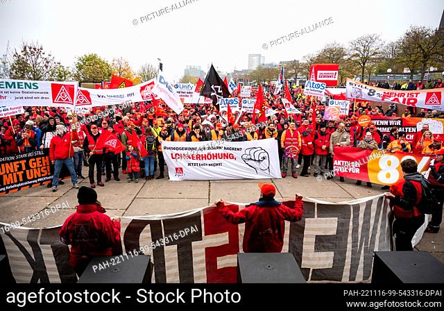 16 November 2022, Hamburg: Workers of the metal and electrical industry stand at a rally on the fish market and hold a banner with the inscription ""Record...