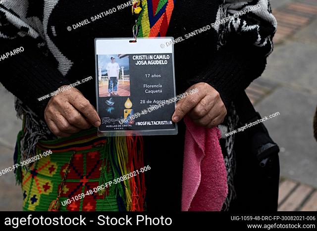 A close relative holds a card with th photo of Cristian Camilo Agudelo, 17 killed on August 28, 2006 during the commemoration of the international day of the...