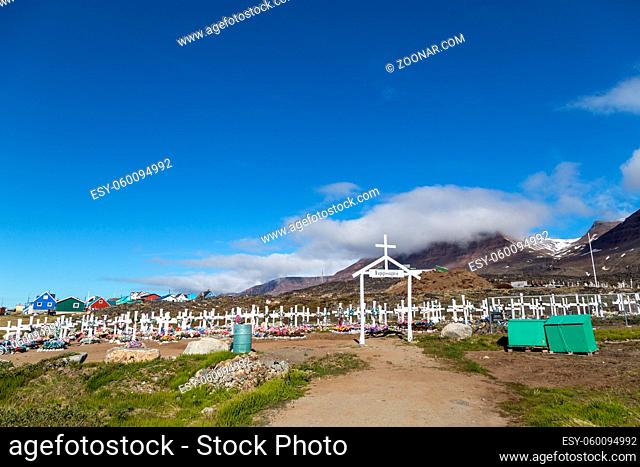 Qeqertarsuaq, Greenland - July 6, 2018: White wooden crosses and artificial flowers on the traditional cemetery