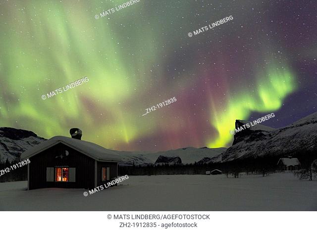 Northernlight in Sarek national park in swedish lapland with a cottage in winter time