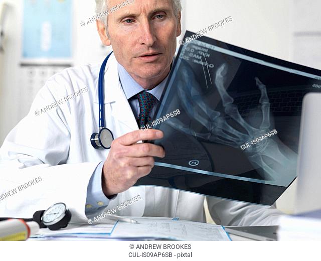 Doctor viewing x-ray of hand in clinic