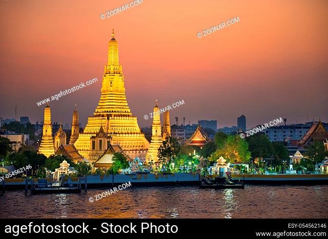 Illuminated Temple of Dawn or Wat Arun at sunset. Bangkok, Thailand