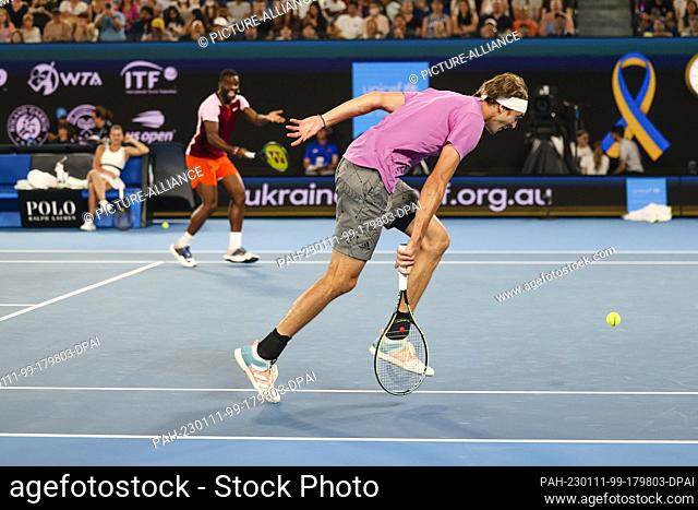 11 January 2023, Australia, Melbourne: Alexander Zverev (r) from Germany and Frances Tiafoe from the USA in action during the tennis benefit ""Tennis plays for...