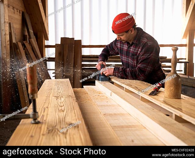 Carpenter working with hand tool at workshop