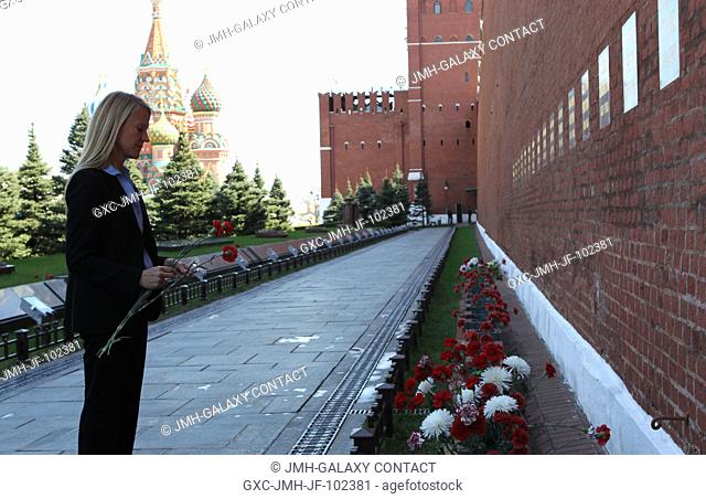 Expedition 3637 Flight Engineer Karen Nyberg of NASA takes a moment to pay tribute to Russian space icons interred in the Kremlin Wall during a tour of Red...