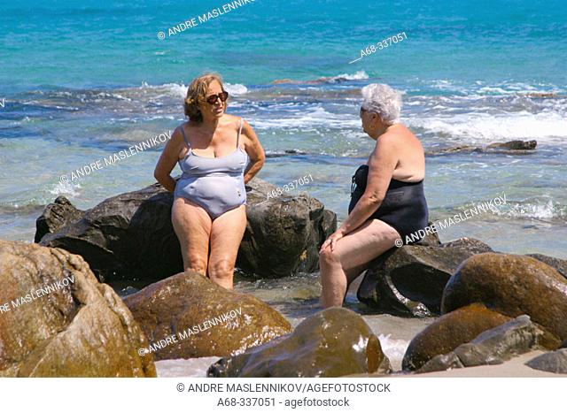 Women at beach. Cefalu. Sicily, Italy