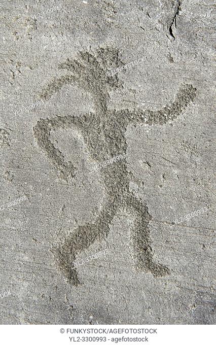 Petroglyph, rock carving, of a warrior with a headress. Carved by the ancient Camunni people in the iron age between 1000-1200 BC