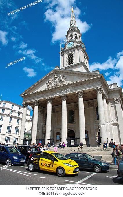 Traffic in front of St Martin in the Fields church Trafalgar square central London England Britain UK Europe