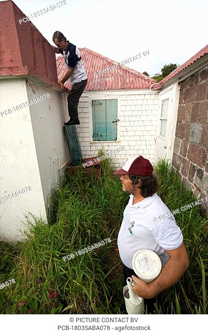 Saba, mosquito control officers are oing door to door checking cisterns