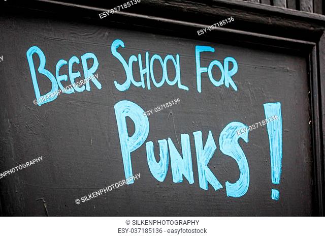 Blackboard with Beer School for Punks! in blue chalk