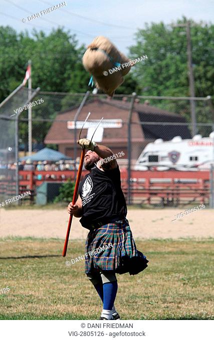 CANADA, UXBRIDGE, 23.07.2011, A Scottish man competes in the sheaf toss during the Heavy Events at the Highlands of Durham Scottish Highland Games