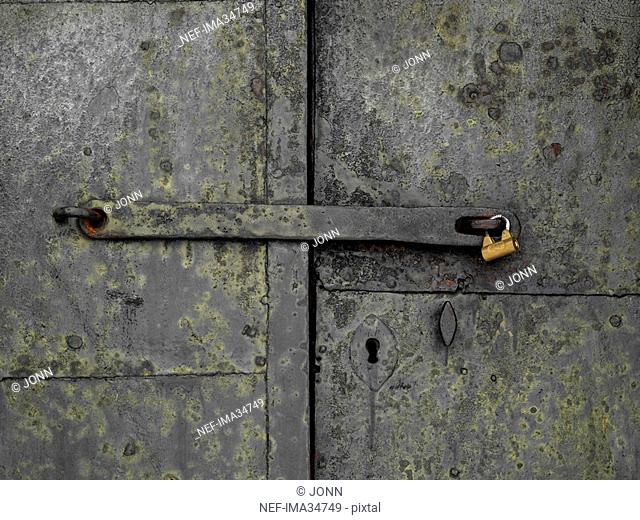 An iron door with a padlock