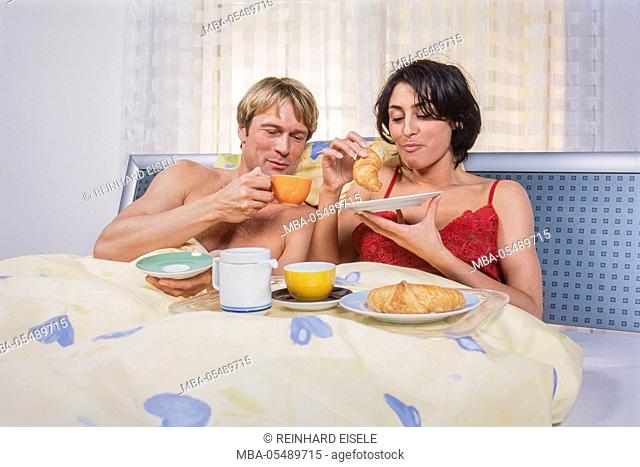 Young couple at the breakfast in the bed