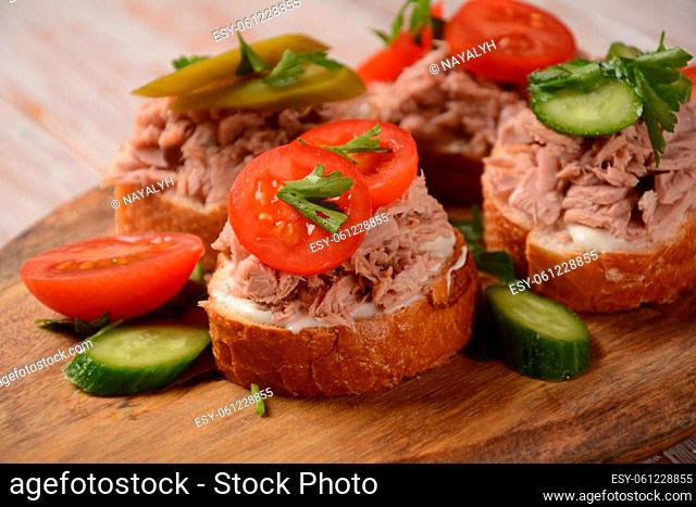 Open sandwich with canned tuna, cucumber, tomatoes, pickled cucumber
