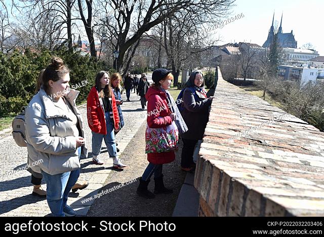 Ukrainian guide Larisa Tkachuk (right), who has lived in Brno, Czech Republic, for a long time, takes her compatriots through Brno, on March 22, 2022