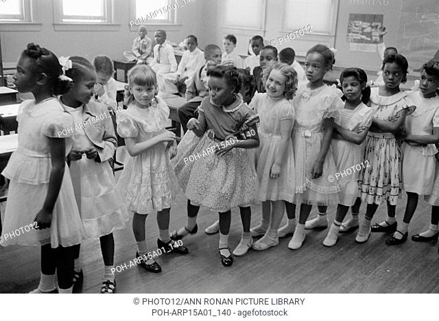 School integration. Barnard School, Washington, D.C. Line of African American and white schoolgirls standing in a classroom while boys sit behind them: 27 May...