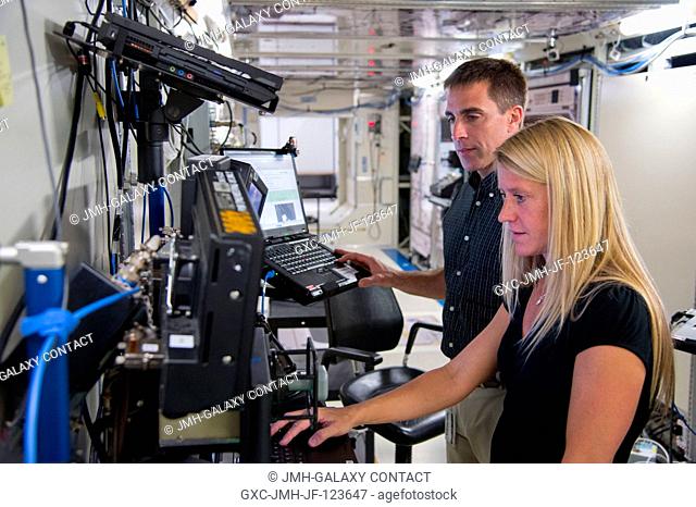 NASA astronauts Karen Nyberg, Expedition 3637 flight engineer; and Chris Cassidy, Expedition 3536 flight engineer, participate in a robotics training session in...