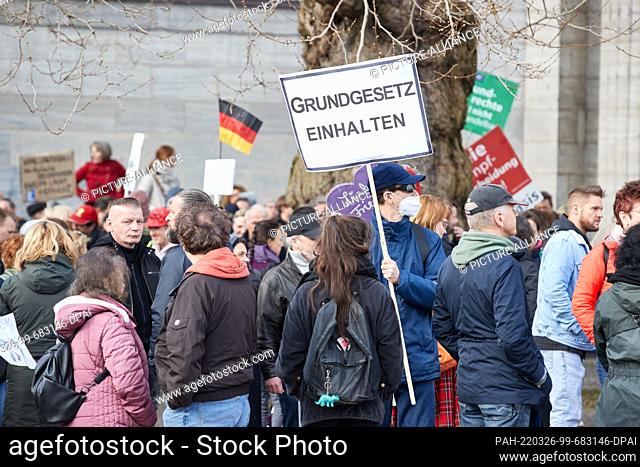 26 March 2022, Hamburg: A participant of the demonstration ""We protect the Constitution! Immediate end to the state of emergency and all pandemic measures