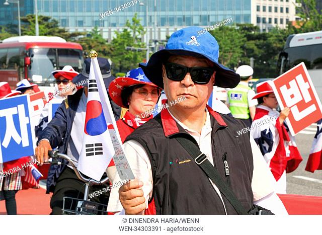 Hundreds of South Koreans march in Seoul as leaders of North and South Korea meet at a border village to discuss the US-North Korea summit
