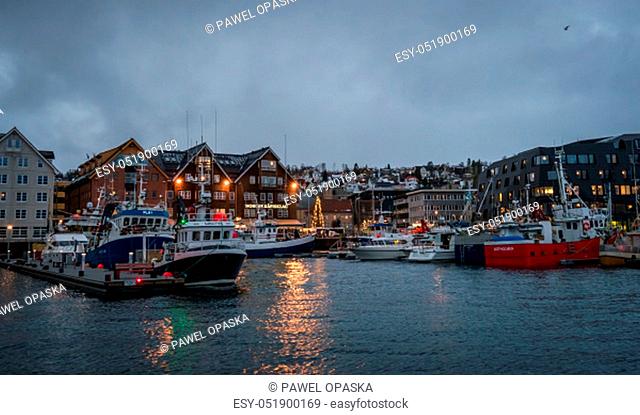 Tromso, Norway - December 2018 : Boats in port and harbour in Tromsoysundet strait in Tromso in winter